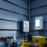 A photograph of a lighting contractor installing an exterior outlet box cover on a residential home