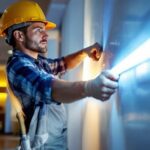 A photograph of a lighting contractor skillfully installing flat led light strips in a modern interior setting