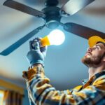 A photograph of a lighting contractor skillfully replacing an led light bulb in a ceiling fan
