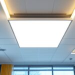A photograph of a modern ceiling featuring a sleek led panel light installation
