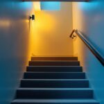 A photograph of a well-lit basement stairway featuring modern lighting fixtures