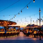 A photograph of a beautifully illuminated outdoor bar setting at dusk