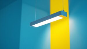 A photograph of a modern linear hanging light fixture installed in a well-lit space