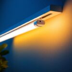 A photograph of a t5 led bulb being installed in a stylish