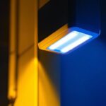 A photograph of a modern battery emergency lighting system installed in a commercial setting