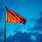 A photograph of a well-lit flagpole at dusk