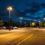 A photograph of a well-lit outdoor parking lot at dusk