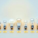 A photograph of a variety of light bulb bases arranged on a clean