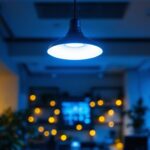 A photograph of a modern office space featuring a stylish ceiling light that highlights the workspace