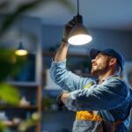 A photograph of a skilled lighting contractor expertly installing or adjusting a modern lighting fixture in a stylish residential or commercial space