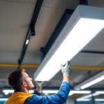 A photograph of a well-lit ceiling fluorescent light fixture installed in a modern commercial space