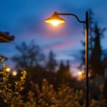 A photograph of a beautifully illuminated outdoor light post in a residential setting