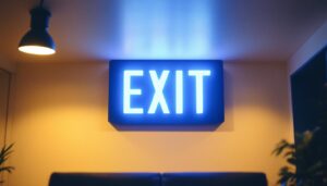 A photograph of a modern commercial exit sign illuminated in a stylishly designed interior space