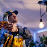 A photograph of a skilled lighting contractor at work