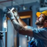 A photograph of a skilled lighting contractor at work