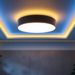 A photograph of a stylish flat ceiling light fixture installed in a modern living space