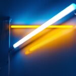 A photograph of a well-lit room showcasing a modern lighting installation project that incorporates old fluorescent lights