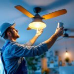 A photograph of a lighting contractor expertly installing stylish light fixtures and ceiling fans in a modern residential setting