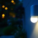 A photograph of a well-lit outdoor setting showcasing a motion-sensing light bulb in action