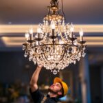 A photograph of a beautifully illuminated chandelier in a stylish interior setting