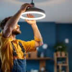 A photograph of a skilled lighting contractor installing a sleek