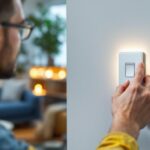 A photograph of a lighting contractor installing a modern wi-fi light switch in a stylish home setting