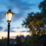 A photograph of a well-lit outdoor scene featuring a lamp post equipped with a motion sensor