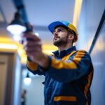 A photograph of a skilled lighting contractor expertly installing maxlite led lights in a modern setting