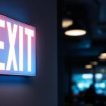 A photograph of capture a photograph of a dual lite exit sign illuminated in a commercial setting