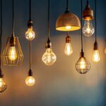 A photograph of a beautifully arranged display of various hanging light fixtures in a stylish home setting