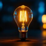 A photograph of a vintage light bulb glowing warmly in a dark setting