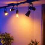 A photograph of a stylish track lighting setup featuring various led light bulbs illuminating a modern interior space