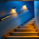 A photograph of a well-lit basement staircase showcasing stylish lighting fixtures that enhance safety and aesthetics