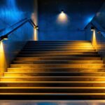 A photograph of a beautifully illuminated indoor staircase featuring smart lighting solutions