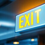 A photograph of a well-lit exit sign in a commercial setting