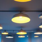 A photograph of a well-lit interior space featuring a variety of stylish led pot light fixtures installed in the ceiling