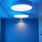 A photograph of a well-lit interior space featuring a modern installation of 2x4 ceiling lights