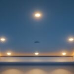 A photograph of a well-lit ceiling featuring various styles of ceiling light canisters installed in a modern home setting