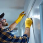 A photograph of a skilled lighting contractor installing a sleek