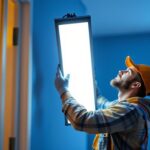 A photograph of a lighting contractor installing or showcasing a 6ft led light in a residential or commercial setting