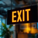 A photograph of a well-lit exit sign in a commercial setting