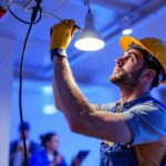 A photograph of a lighting contractor expertly installing a light fixture