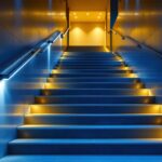 A photograph of a well-lit stairwell featuring sleek led lights that highlight the steps and walls