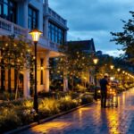 A photograph of a beautifully illuminated outdoor space featuring stylish electric post lights
