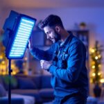 A photograph of a lighting contractor actively installing or showcasing a set of led lights in a well-lit