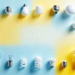 A photograph of a variety of light bulb bases arranged aesthetically on a clean