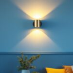 A photograph of a stylishly designed wall sconce in a well-lit interior setting