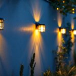 A photograph of a beautifully illuminated outdoor wall featuring stylish solar lights