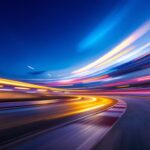 A photograph of a dynamic light race track at dusk