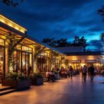 A photograph of a beautifully illuminated outdoor commercial space at dusk